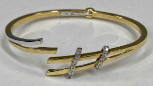 CONTINENTAL 18CT GOLD BANGLE - with 12 tiny diamonds, set in two white gold looped bands, 15.