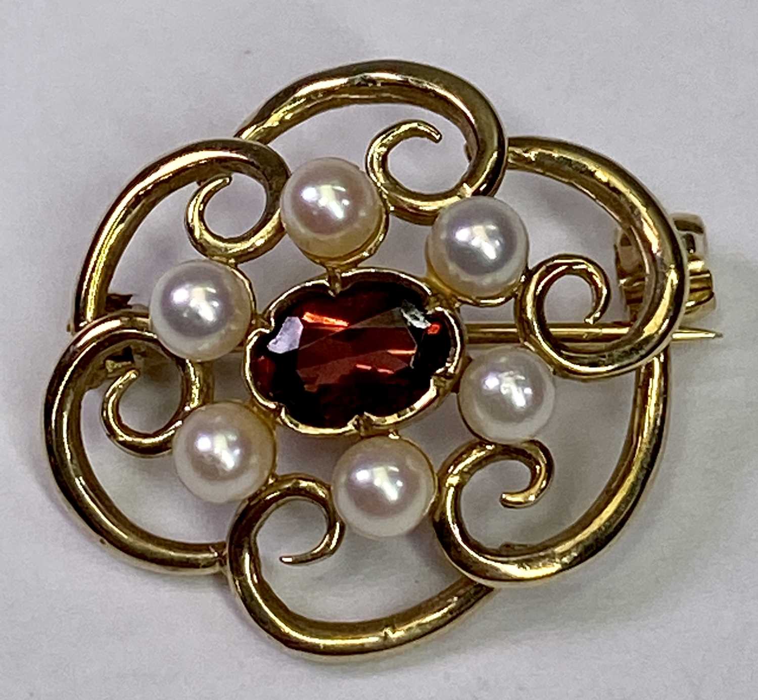 ANTIQUE 9CT GOLD OPENWORK BROOCH - with centrally mounted garnet and seed pearl surround, 22 x 19mm,