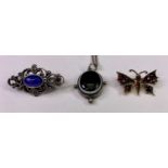 SCROLLED SILVER PIN BROOCH with oval centre lapis, a yellow metal backed butterfly brooch and a