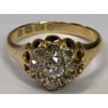 18CT GOLD DIAMOND CLUSTER DRESS RING - having a small centre diamond, visual estimate, 0.4ct with