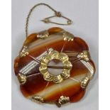 AGATE BROOCH - shaped edge with safety chain, having 9ct mounts and centre, 12.5grms gross