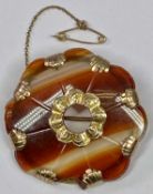 AGATE BROOCH - shaped edge with safety chain, having 9ct mounts and centre, 12.5grms gross