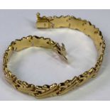 18CT GOLD '750' STAMPED POLSERA BRACELET - of double cross links with clip fastener, 20cms overall L