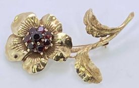 FINE GOLD PIN BROOCH - with a flower having a centre cluster of tiny rubies, gold mark indistinct (