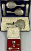 CASED 5 PIECE SILVER DRESSING TABLE, HAND MIRROR & BRUSH SET and a cased egg cup and spoon set,