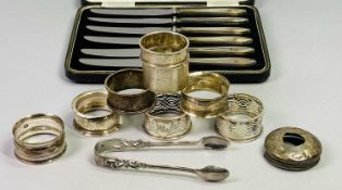 SILVER SUGAR NIPS, A PAIR with scrolled design, London 1987, 1ozt, and 7 x silver napkin rings