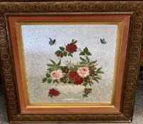A FLORAL PAINTED BEVELLED WALL MIRROR in a carved oak frame, 57 x 57cms