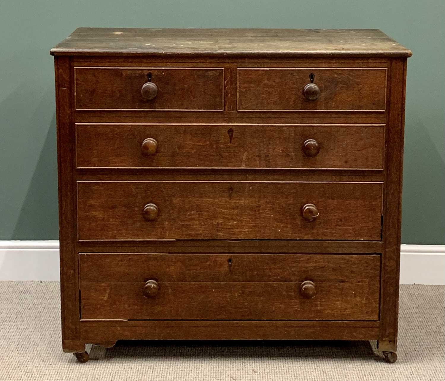 ANTIQUE OAK CHEST of two short over three long drawers with turned wooden knobs, on castors,
