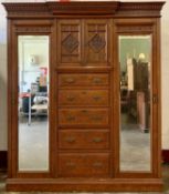 ANTIQUE WALNUT COMBINATION WARDROBE having bevelled mirrored glass doors flanking a central twin