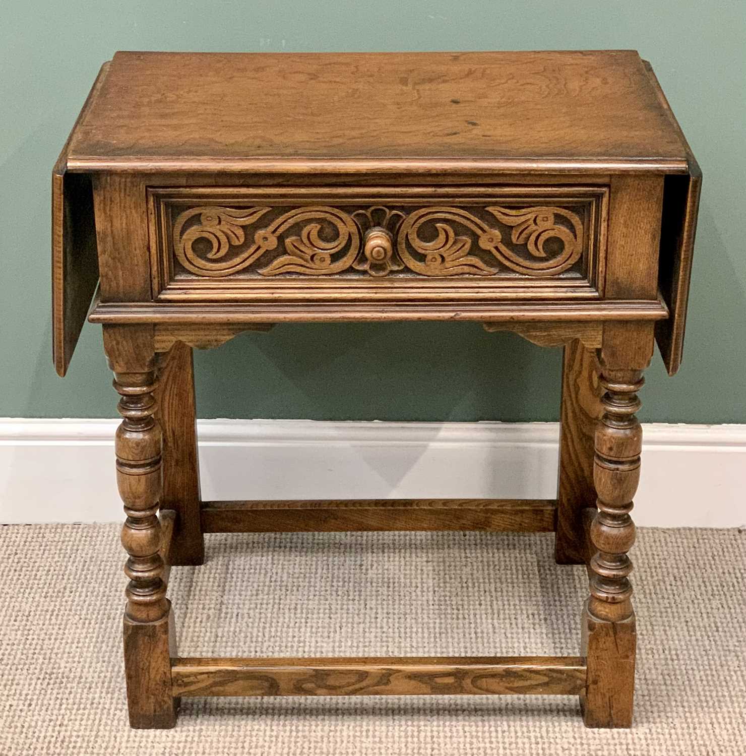 RUSTIC OAK & CARVED SINGLE DRAWER SIDE TABLE with twin flap ends, on turned and block supports,
