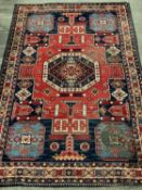 EASTERN TYPE WOOLLEN RUG, blue and red ground with multi-pattern border and octagonal pattern