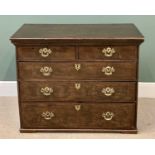 GEORGIAN OAK CHEST of two short over three long drawers with pierced brass backplates, escutcheons