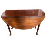 Reproduction mahogany drop leaf table on pad feet