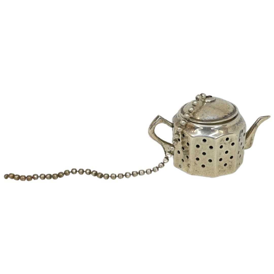 Silver Tea Strainer In a Figure Of A Tea Pot