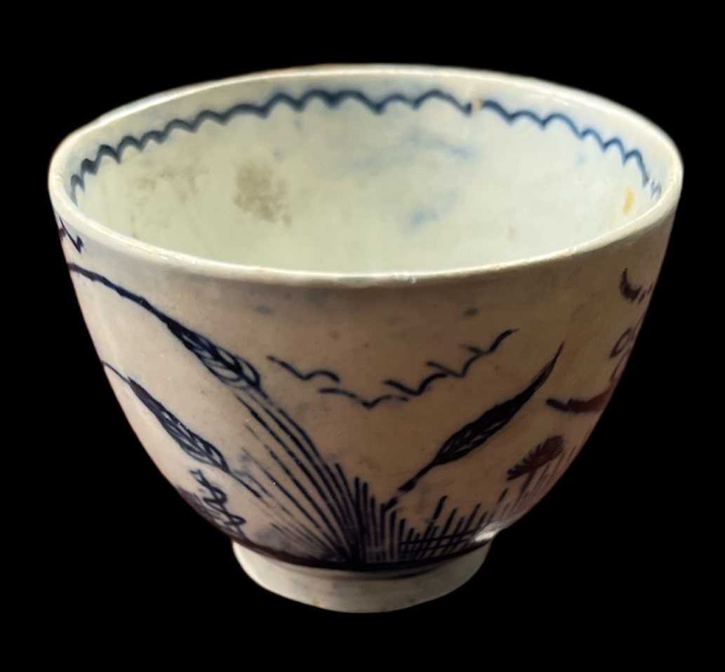 A late 18th century English pearlware cup with traditional Chinese scene decoration