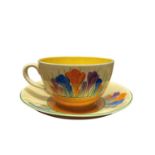 A Clarice Cliff Globe Shaped Breakfast Cup and Saucer in Autumn Crocus