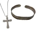 A White Metal Bangle and Cross Necklace.