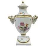 A Furstenberg porcelain vase and cover with gilded ram handles