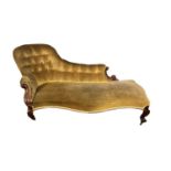 A Victorian mahogany framed chaise longue in golden upholstery