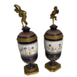 Pair of Continental Porcelain and Gilt Metal Lidded Urns, Decorated with Putti