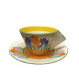 A Clarice Cliff Teacup and Saucer with Solid Conical Handle in Autumn Crocus
