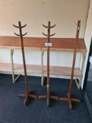 Four Oak Hat and Coat Stands and One Metal Hat and Coat Stand