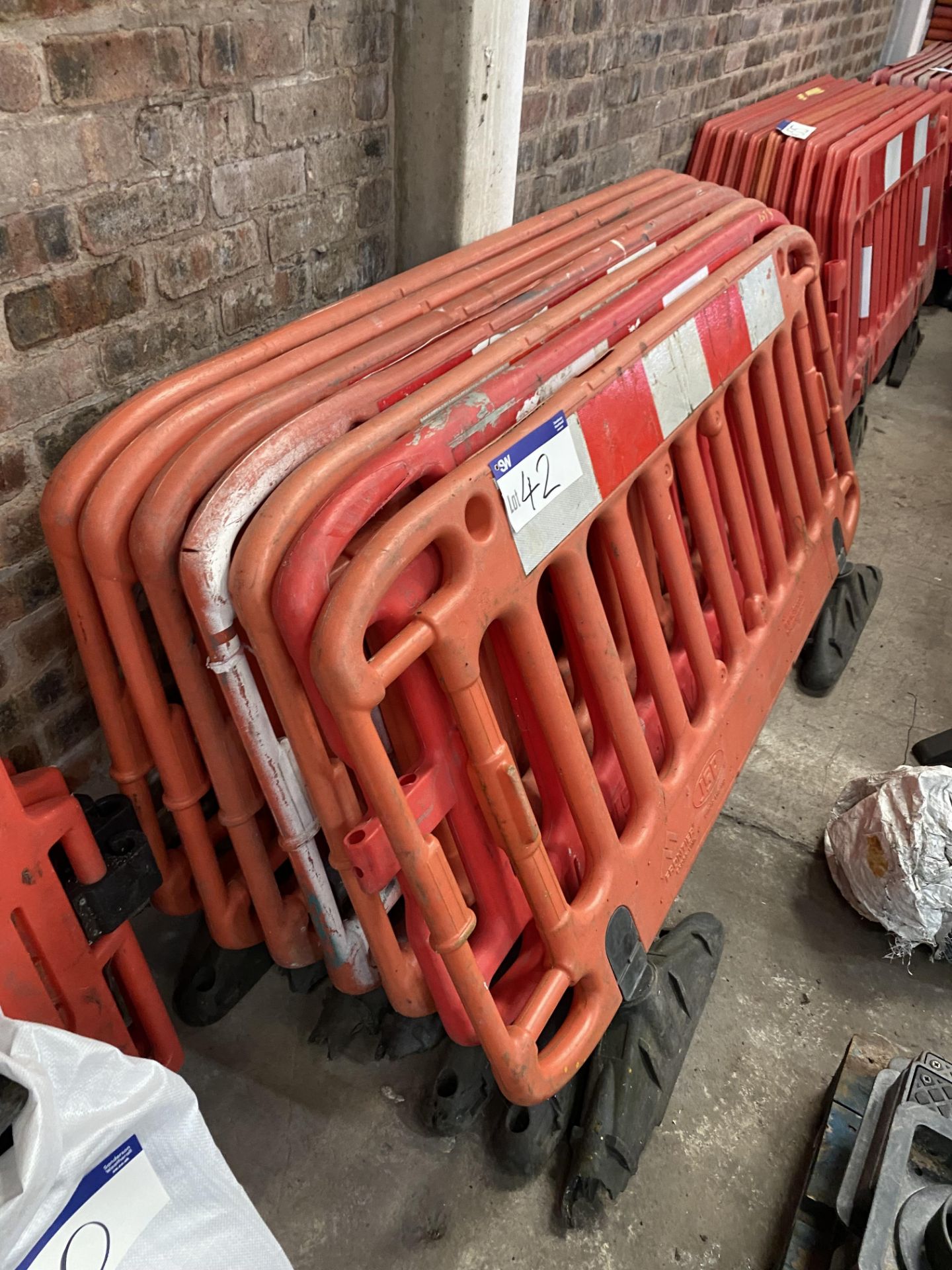 Seven Mainly JSP Plastic Barriers, each with feet (no vat on hammer price on this lot - however