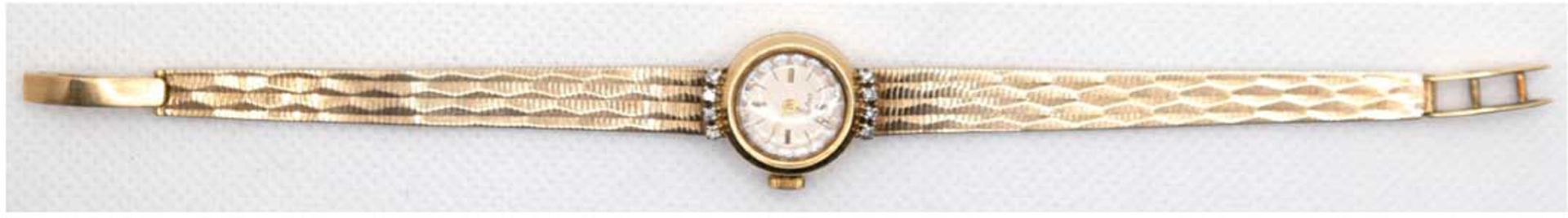 Damen-Armbanduhr "Dugena", 585er GG, 19,2 g, rundes Gehäuse besetzt mit 8 Brillanten, mechanisches 