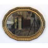 Salonspiegel, um 1920, Holz mit Stuckverzierungen, vergoldet, ovale, polygonale Form, 78x96 cm