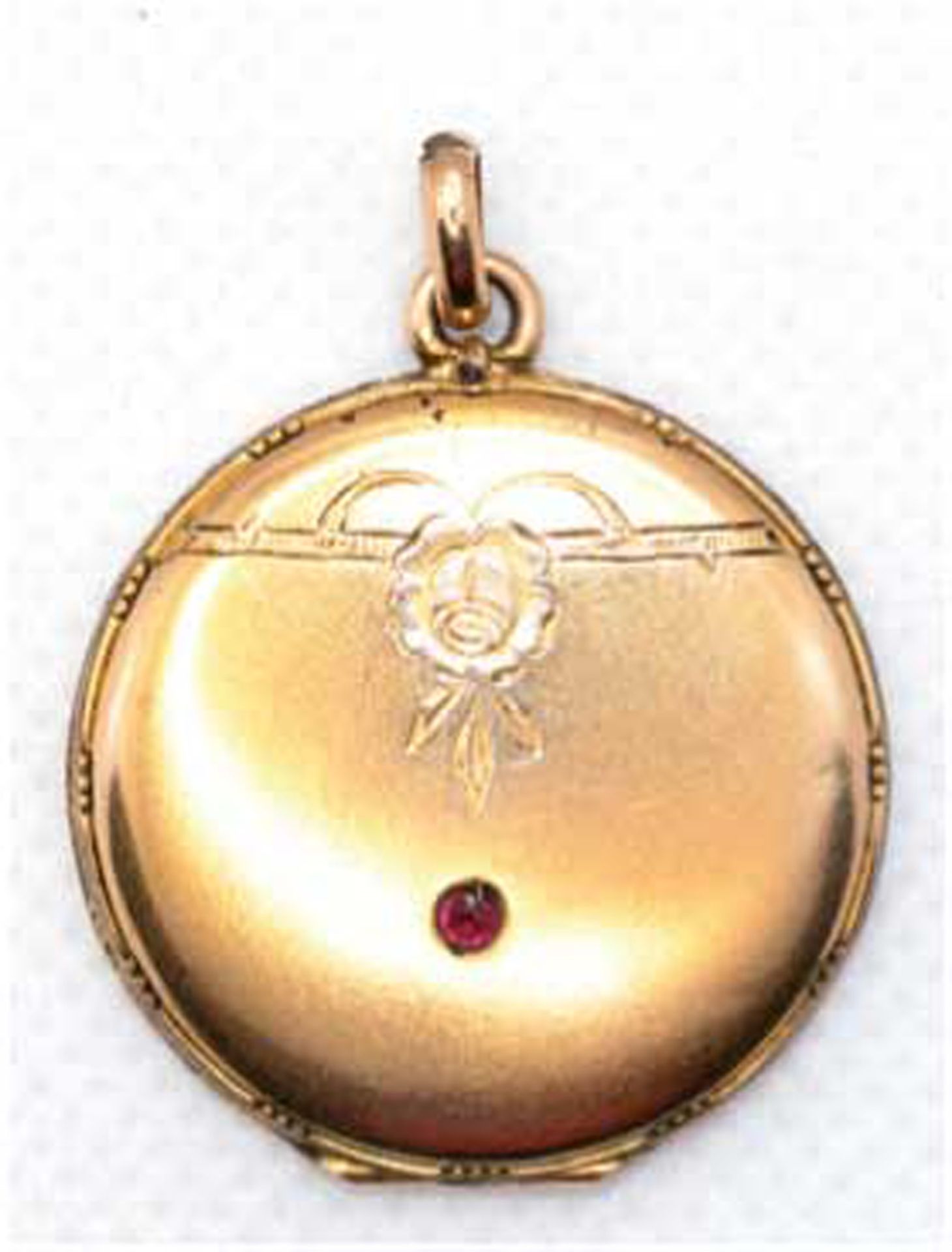 Medaillon um 1900, Golddouble, mit zeittypischem Dekor und rotem Schmuckstein, Durchmesser ca. 2,7 