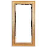 Spiegel, mit Facettenschliff, figürlich reliefierte Rahmenleiste, ges. 148x72 cm