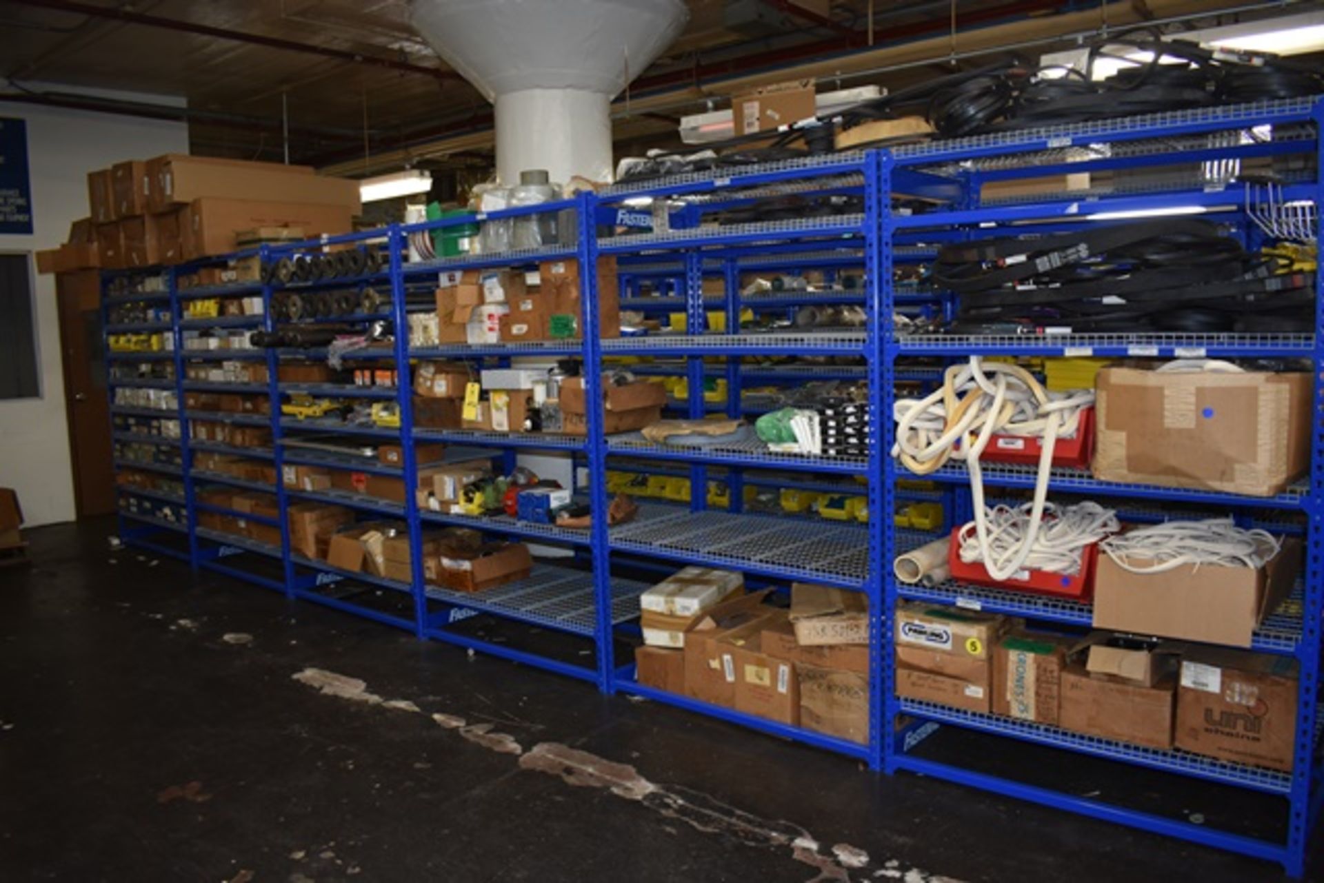 Contents of Blue Fastenal shelving including: V-belts, carlock, conveyor parts, etc. Five rows of