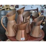 A Set of six Copper Jugs. tallest 23 cm approx.