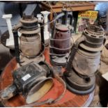 Three 19th Century storm Lanterns along with a coaching Lamp. H 32 cm approx.