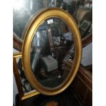 A late 19th Century oval Timber Gilt Mirror with bevelled glass. 46 x 67 cm approx.