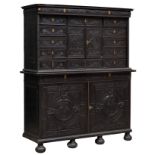 Louis XIII style cabinet; France, 18th century. Carved and ebonised wood. One of the legs is