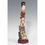 Guanyin sculpture; China, Quing Dynasty, late 19th century.Polychrome elephant ivory.Attached