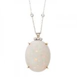 18kt yellow gold claw set opal pendant with 18kt white gold chain and diamonds.White opal with an