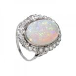 Ring in 18kt white gold, opal with beautiful play of colours in oval cut of about 12 cts.Lined
