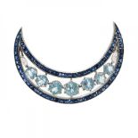 Platinum half moon brooch with aquamarines and sapphires.Prong and pin clasp. Estimated weight