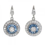 Pair of long earrings in platinum. With central diamonds, J color, SI1 clarity with a border of