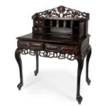 Desk. Hong Kong, second half of the 19th century.Carved Hongmu wood.Signed on the locks of the