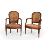 Pair of Louis XV armchairs. France, ca. 1750.Walnut wood. Petit point" upholstery.In need of