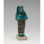 Ushebti. Egypt, Late Antiquity.Fayenza.Measurements: 8 cm (height) .Ushebtis are small statuettes