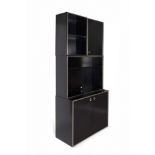 Modular bookcase. Italy, 1970s.Black lacquered laminated wood with chromed metal profiles and