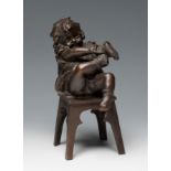 JUAN CLARÀ I AYATS (Olot, Girona, 1875 - Barcelona, 1958)."Boy putting on his shoe".Patinated