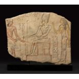 Fragment of an Egyptian relief with a scene of an offering to the god Osiris. Ancient Egypt,