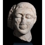 Female bust; Cyprus, c. 700 BC.Stone.Damaged nose and cheek.Size: 24 x 7.5 cm.This head fragment