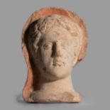 Male votive head; Etruria, circa 3rd century BC.Terracotta.It has traces of polychromy.There are