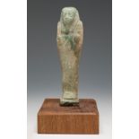 Ushebti; Egypt, Lower Egypt, Ptolemaic period, 2nd-1st century BC.Fayenza. Wooden base.Attached